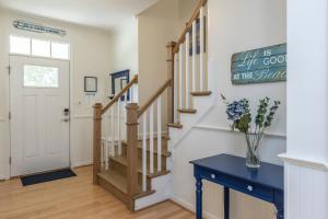 a staircase in a home with a blue table at Incredible Location in Virginia Beach