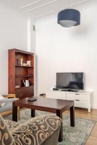 萊格尼察的住宿－Apartament ROZETA centrum 6os，客厅配有桌子和电视