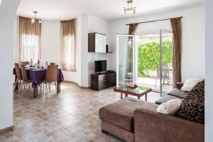 a living room with a couch and a table at Villa Dalia by Villa Plus in Beniarbeig