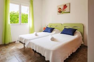 two beds in a room with two windows at Villa Dalia by Villa Plus in Beniarbeig +16 photos