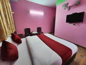 um quarto com uma cama e uma parede rosa em Boho Stays near mall em Shimla