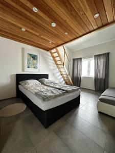 a bedroom with a bed and a wooden ceiling at Paradies in den Bergen nahe Garmisch Partenkirchen in Eschenlohe