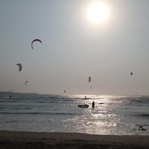 a group of people flying kites in the ocean at Hotel Juanmar in Juan de Acosta