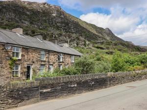 an old stone house on the side of a mountain at 3 Barlwyd Terrace in Blaenau-Ffestiniog