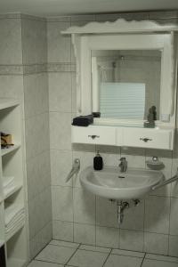 a bathroom with a sink and a mirror at Breakfast in bed in Hörschhausen +15 photos