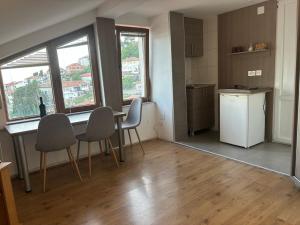 a kitchen with a table and chairs in a room at Apartments ANJA lake view in Ohrid