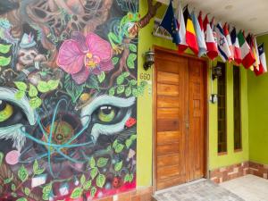 a wall with a painting on the side of a building at Moicca Youth Hostel in Iquitos