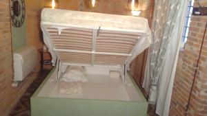 a small room with a bed in a bathroom at La Porta Verde in Lucca