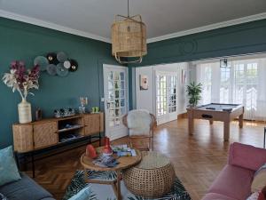 a living room with a couch and a table at Entre Terre et Mer in Plougoulm