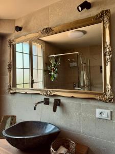 a bathroom with a large mirror and a sink at Villa Patty in Marzamemi +39 photos