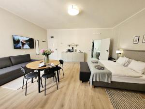 Una sala de estar con una cama y una mesa con sillas. en Anny 5 Apartamenty, en Cracovia
