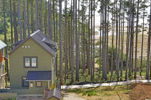 a small house in the middle of a forest of trees at Seaforever by Seabrook Hospitality in Pacific Beach