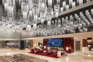 a lobby with a large chandelier hanging from the ceiling at Taj Santacruz in Mumbai
