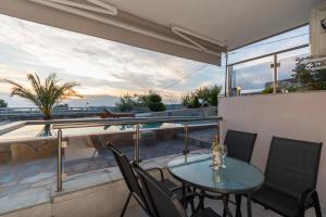 a patio with a table and chairs on a balcony at Art Studios in Neos Marmaras