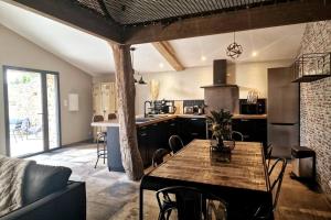 a kitchen with a table and a dining room at L'Escale Nobilienne in Nouaillé-Maupertuis