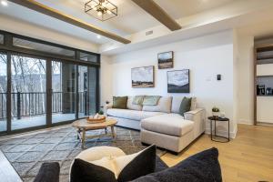 a living room with a couch and a table at Tremblant Prestige - Verbier 4-102 in Mont-Tremblant