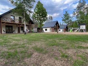 a house with a large yard in front of it at Green House Relax in Płaska