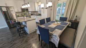 a kitchen and dining room with a table and chairs at Harmony Haven in Lower Sackville