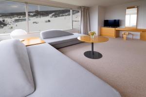 ein Wohnzimmer mit einem Sofa und einem Tisch in der Unterkunft ANA Crowne Plaza Resort Appi Kogen, an IHG Hotel in Hachimantai
