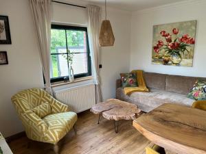 a living room with a couch and a table at Haus Schönsee - 2 Apartments, ideal für Familien & Freunde in Heede