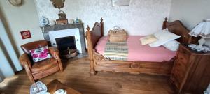 a bedroom with a wooden bed and a fireplace at agréables chambres d'hôtes près du centre ville avec jardin in Le Mans