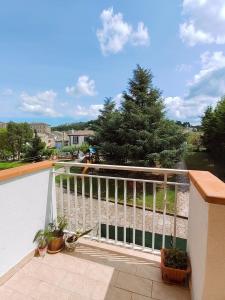 a balcony with a white railing and a tree at Lully&Jeky -Casa vacanze- in Recanati