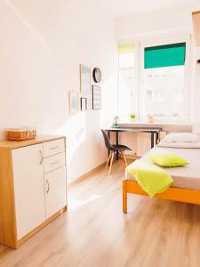 a bedroom with a bed and a desk and a table at Nocleg - Gdynia Śródmieście in Gdynia