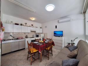 - une cuisine et une salle à manger avec une table et un canapé dans l'établissement Apartment Mangus, à Split