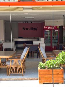 a table and chairs in front of a restaurant at Rose Hotel in Erdemli