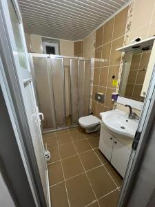 a bathroom with a toilet and a sink and a shower at Rose Hotel in Erdemli