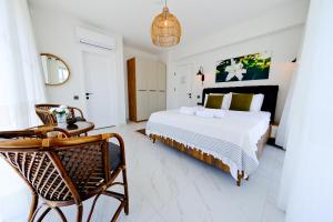 a bedroom with a bed and a table and chairs at Lily of the Valley Luxury Villa Fethiye, Yesiluzumlu by Sunworld Villas in Fethiye +32 photos