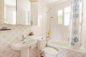 a bathroom with a toilet and a sink and a tub at Сozy House in Alicante +2 photos