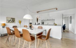 a kitchen and dining room with a table and chairs at Amazing Home In Odder With Kitchen in Odder
