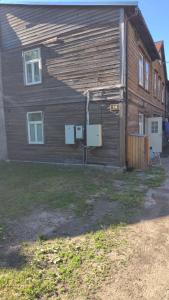 a wooden house with a yard in front of it at City apartment in Pärnu