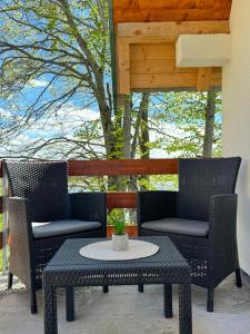 a patio with two chairs and a table on a patio at Mountain Houses Šarović in Žabljak