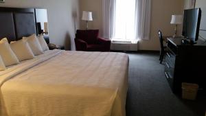 a hotel room with a large bed and a television at GOLD VAULT INN in Radcliff +2 photos