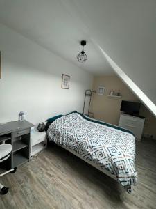 sypialnia z łóżkiem i biurkiem w obiekcie Chambre chez thomas w mieście Glos-sur-Lisieux