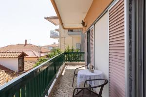 a balcony with a table and chairs on a balcony at Litochoro Olympus Studio in Litochoro
