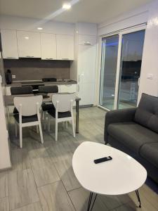 a living room with a couch and a table at Maja Apartmani in Sutomore