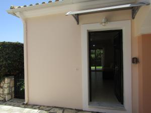 a door into a house with a mirror at Vivere Apartment Barbati Beach in Barbati +36 photos