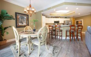 a dining room and kitchen with a table and chairs at Phoenix on the Bay 1214 condo in Orange Beach