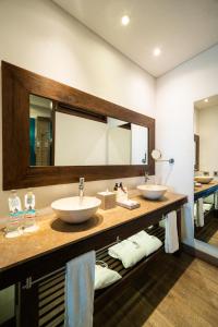 a bathroom with two sinks and a large mirror at Sophia Hotel in Cartagena de Indias