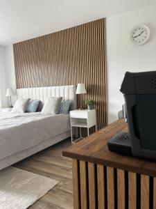 a bedroom with a bed and a desk with a computer at Isaak Appartement Harmonie in Küssaberg