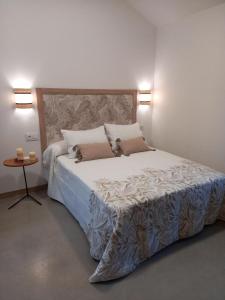 a bedroom with a large bed with two pillows at Veiga Mariña in A Xesteira