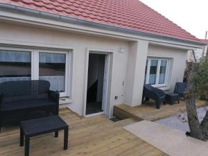 a house with a wooden deck with furniture on it at Maison conviviale à Farschviller in Farschviller