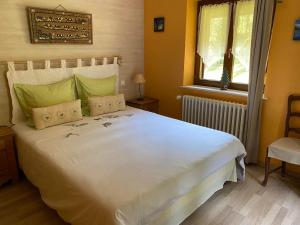 a bedroom with a large white bed and a window at Chambres d'Hôtes des Cascades St-Nicolas in Kruth +110 photos