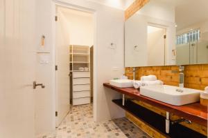 a bathroom with two sinks and a mirror at Casa Love by Wynwood House in Panama City +175 photos