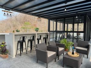 a patio with a bar with chairs and tables at Nabani Condominios T3 in Santa Cruz Huatulco