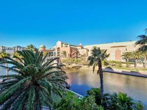 a view of a city with palm trees and buildings at Renovated, Pools, Park, Gym, Parking, Canal walk access in Cape Town