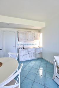 a kitchen with a table and a table and chairs at Ancora Resort in Acciaroli